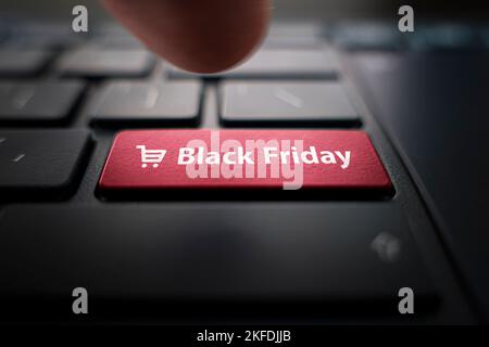 Black friday text and shopping cart on keyboard. Black friday concept. black button on the keyboard of modern ultrabook. caption on the button. Stock Photo