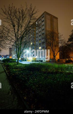 18 November 2022, Saxony-Anhalt, Magdeburg: The first lights are burning in the windows of a high-rise residential building in the capital of Saxony-Anhalt. In order to avoid delays in the transfer of housing subsidies, the Chief Executive of the German Association of Towns and Municipalities advocates uncomplicated advance payment at the beginning of the year. Normally, the offices would need five to seven months to process the applications, but due to the multiplication of applications, this would now take even longer. Because of the high energy prices, however, people are dependent on the h Stock Photo