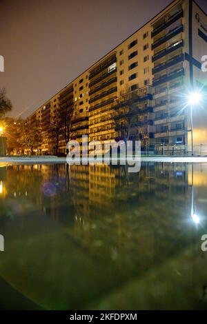 18 November 2022, Saxony-Anhalt, Magdeburg: The first lights are burning in the windows of a high-rise residential building in the capital of Saxony-Anhalt. In order to avoid delays in the transfer of housing subsidies, the Chief Executive of the German Association of Towns and Municipalities advocates uncomplicated advance payment at the beginning of the year. Normally, the offices would need five to seven months to process the applications, but due to the multiplication of applications, this would now take even longer. Because of the high energy prices, however, people are dependent on the h Stock Photo