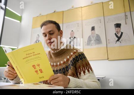 Xi'an, China's Shaanxi Province. 9th Nov, 2022. Philippe Emmanuel Couste reads a French book related to traditional Chinese medicine in Xi'an, northwest China's Shaanxi Province, Nov. 9, 2022. TO GO WITH 'Across China: French expat promotes traditional Chinese medicine' Credit: Li Yibo/Xinhua/Alamy Live News Stock Photo