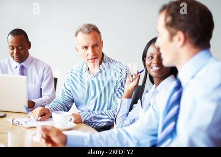 Executives collaborating. Team of executives collaborating in board room. Stock Photo
