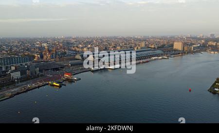 A drone photo aerial view of the Ij docklands and Amsterdam Centraal Station on the waterfront, Amsterdam, Netherlands Stock Photo
