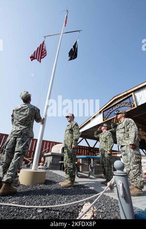 CAMP LEMONNIER, Djibouti (Sept. 11, 2022) During a ceremony this morning at Camp Lemonnier, Djibouti (CLDJ) the United States Flag was lowered to half-staff in order remember the 2,977 victims of the terrorist attacks on our nation that occurred on 11 September 2001.  Camp Lemonnier's leadership and Chief's Mess wanted to take the opportunity to reflect on the victims of this attack as well as those who served and gave the ultimate sacrifice supporting the Global War on Terrorism. As Americans, we chose to commemorate this day with act of service and remembrance. CLDJ serves as an expeditionar Stock Photo