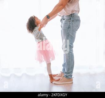 Father, child and dance in ballet tutu for fun, bonding and artistic expression with love and care in childhood. Dancer, dancing and man with daughter Stock Photo