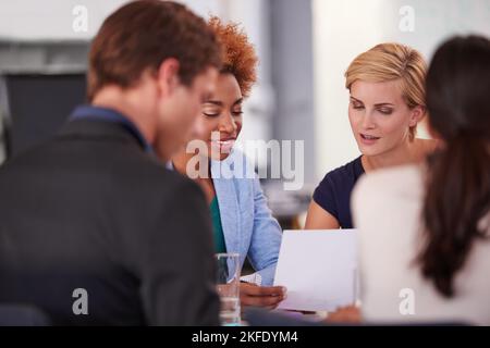 Taking a look at the paperwork. businesspeople in a meeting. Stock Photo