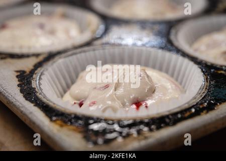 Raw cupcake dough in a baking tin Stock Photo