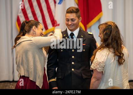 2nd Lt. Cameron Holdsworth is pinned his new rank by his fiancé and ...