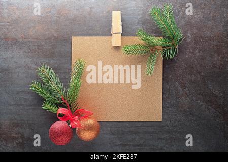 Christmas tree branches with paper card note. Flat lay. Nature New Year concept. Stock Photo