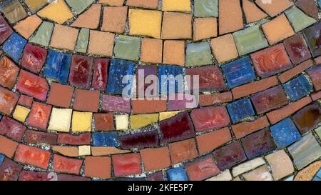 Old dirty vintage mosaic made of colored pieces in close-up Stock Photo