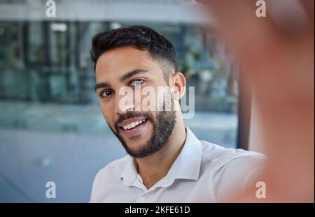 Business man, selfie and smile for socila media profile picture with happiness and pride in career choice while at office. Face of professional male Stock Photo