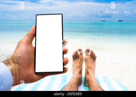 Mobile Phone Or Smartphone With Green Screen On Beach Stock Photo