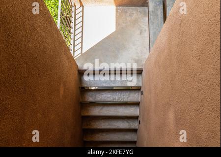 Top view of Cement stairs with sunlight in brown soil wall at resort Stock Photo