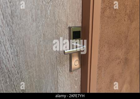 Digital door lock with key card entry system on wooden door Stock Photo