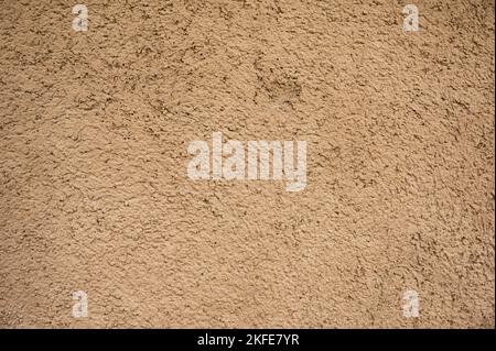 Weathered natural brown clay soil house wall texture background Stock Photo