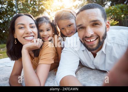 Relax, happy and selfie with family on picnic for summer, support or bonding in park. Smile, freedom and affectionate with portrait of parents and Stock Photo