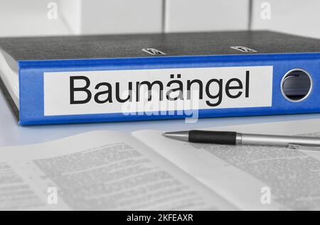 Folder with the label Construction defects in german - Baumängel Stock Photo