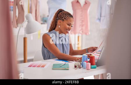 Fashion, design and laptop with a black woman seamstress working in her workshop for creative or trendy clothing production. Computer, ecommerce and Stock Photo