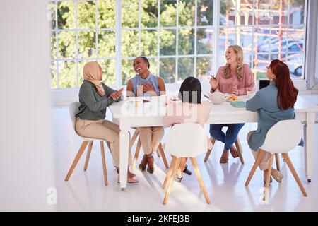 Collaboration, food and team building with a business woman group sitting around a table for eating. Meeting, partnership and lunch with a female Stock Photo