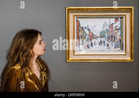 London, UK. 18th Nov, 2022. Street Scene by L. S. Lowry, leads Bonhams Modern British and Irish Art sale in London on 22 November 2022. The painting, which has been in the same family for almost 50 years, is estimated at £800,000-1,200,000. Credit: Guy Bell/Alamy Live News Stock Photo