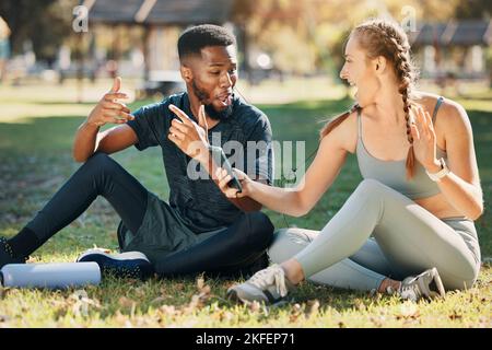 Music, phone and earphone couple in park on fitness run break rap, singing and listen together. Streaming, tech and interracial people listening to Stock Photo