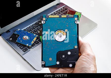 Hard disk drives are still widely used, hard drives in hand. Stock Photo