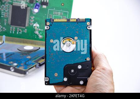 Hard disk drives are still widely used. hard drive in hand (Cut path included in this picture) Stock Photo