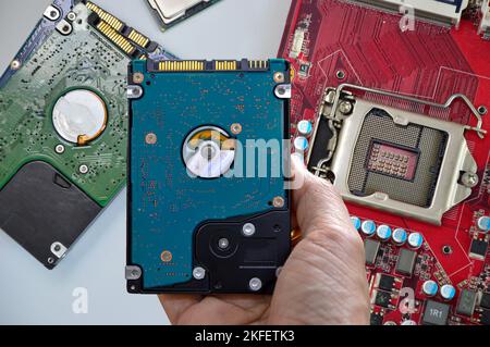 Hard disk drives are still widely used. hard drive in hand Stock Photo