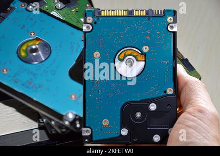 Hard disk drives are still widely used. hard drive in hand Stock Photo