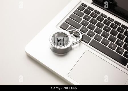 Code-locked padlock on the laptop computer. internet security and Computer security Concept. Stock Photo