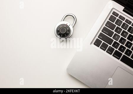 Code-locked padlock on the laptop computer. internet security and Computer security Concept. Stock Photo