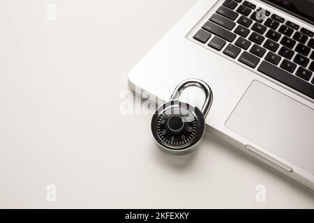 Code-locked padlock on the laptop computer. internet security and Computer security Concept. Stock Photo