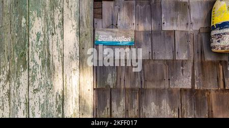 small handpainted sign for southampton, ny hanging on the side of an old building Stock Photo