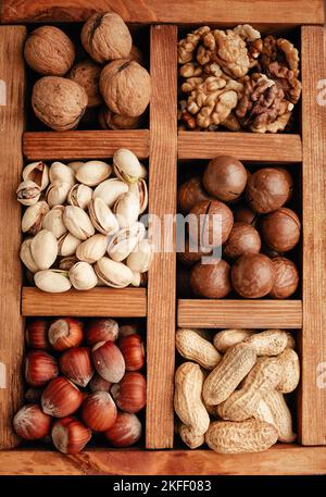 Different nuts in a wooden box. Stock Photo