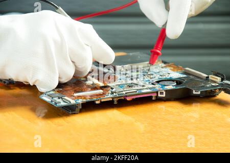 side view mechanic repairing motherboard Stock Photo