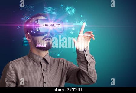 Businessman looking through Virtual Reality glasses Stock Photo