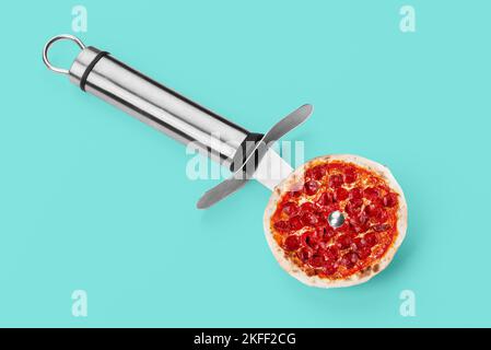 Pizza knife. Modern art collage. Salami pepperoni pizza and pizza knife. Modern food concept. Stock Photo