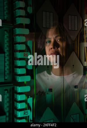 KAENA POINT SPACE FORCE STATION, HI. – Chancy Cabrea, Space Delta 6 – Cyberspace Operations, Satellite Control Network maintainer, is reflected in the equipment panels of an operations floor at Kaena Point Space Force Station, Hawaii, Sept. 13, 2022. The Kaena Point Satellite Tracking Station was renamed to reflect its role in the U.S. Space Force in June 2021. Stock Photo