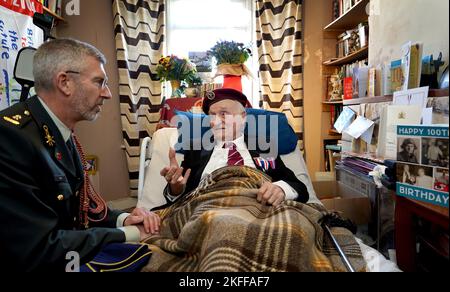 Peter Colthup, a WWII veteran with the Glider Pilot Regiment who celebrated his 100th birthday on Thursday, after he received the Dutch Liberation Medal and the Market Garden Medal from Lieutenant Colonel Richard Piso (left), Military Attaché, Embassy of the Kingdom of the Netherlandsat his home in Whitstable. Picture date: Friday November 18, 2022. Stock Photo