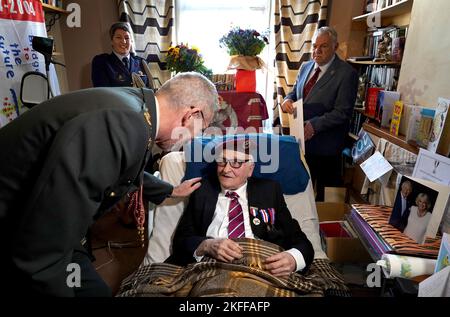 Peter Colthup, a WWII veteran with the Glider Pilot Regiment who celebrated his 100th birthday on Thursday, receives the Dutch Liberation Medal and the Market Garden Medal from Lieutenant Colonel Richard Piso, Military Attaché, Embassy of the Kingdom of the Netherlands, at his home in Whitstable. Picture date: Friday November 18, 2022. Stock Photo