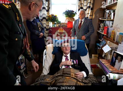 Peter Colthup, a WWII veteran with the Glider Pilot Regiment who celebrated his 100th birthday on Thursday, receives the Dutch Liberation Medal and the Market Garden Medal from Lieutenant Colonel Richard Piso, Military Attaché, Embassy of the Kingdom of the Netherlands, at his home in Whitstable. Picture date: Friday November 18, 2022. Stock Photo