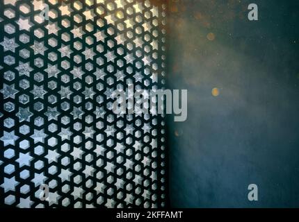 Amazing moonlight through window holes with oriental forms. Dark room with beams and shadows on a wall inside. Stock Photo