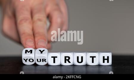 Hand turns dice and changes the expression 'your truth' to 'my truth'. Stock Photo