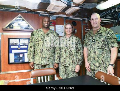 NORFOLK (Sept. 14, 2022) Command Master Chief Joseph Williamson, Chief of the Boat, USS New Mexico (SSN 779), Vice Adm. Kelly Aeschbach, Commander, Naval Information Forces and Executive Officer LCDR Douglas K. McKenzie, USS New Mexico (SSN 779) pose for a photo during a tour of the submarine. The USS New Mexico (SSN 779) is a Virginia-class attack submarine which is also known as the VA-class or 774-class, a class of nuclear-powered fast attack submarines. USS New Mexico is one of two SSNs participating in the Information Warfare (IW) Pilot program, which assigns IW officers and Sailors about Stock Photo