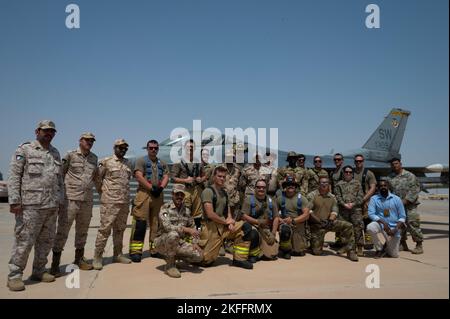 Airmen from the 386th Expeditionary Civil Engineer Squadron and Kuwait Army firefighters held a training exercise, September 15, 2022. Firefighters from the 386th ECES held a fire attack exercise on an F-16CM Fighting Falcon, which included simulating putting out an aircraft fire and rapidly opening the canopy to evacuate the pilot to safety. ACE,Coalition Partners,MCA,Operation Agile Spartan III,airmen, Stock Photo