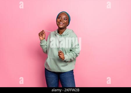 Photo of adorable good mood dancing woman in urban modern clothes look isolated on pink color background Stock Photo