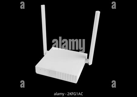 Wireless Wi-Fi router isolated on black background. wifi technology concept. White wireless internet router isolated. Cable modem with antenna isolate Stock Photo