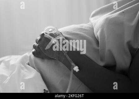 A pregnant woman in labor, lying in a hospital bed waiting for her baby to be born. Stock Photo