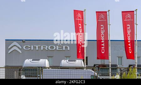 Belgrade, Serbia - August 19, 2022: Red Flags at French Car Citroen Dealership and Service Garage at Highway. Stock Photo