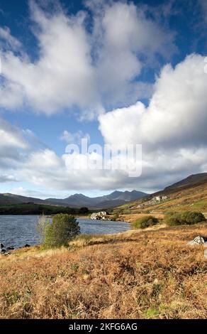 Photograph of Llyn Mymbyr with distant views of the Snowdon range of mountains in Snowdonia National Park Gwynedd North Wales United Kingdom Europe Stock Photo