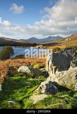 Photograph of Llyn Mymbyr with distant views of the Snowdon range of mountains in Snowdonia National Park Gwynedd North Wales United Kingdom Europe Stock Photo